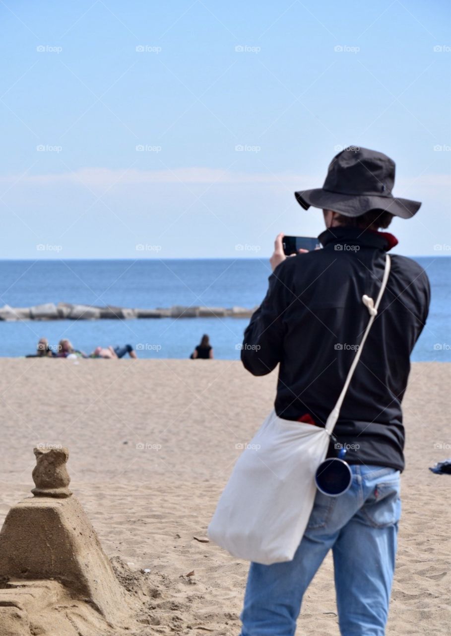 Man taking pictures on the beach 