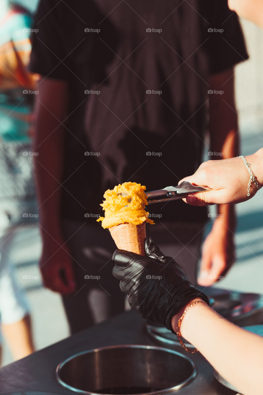 Young boy buying icecream in a candy shop by a street