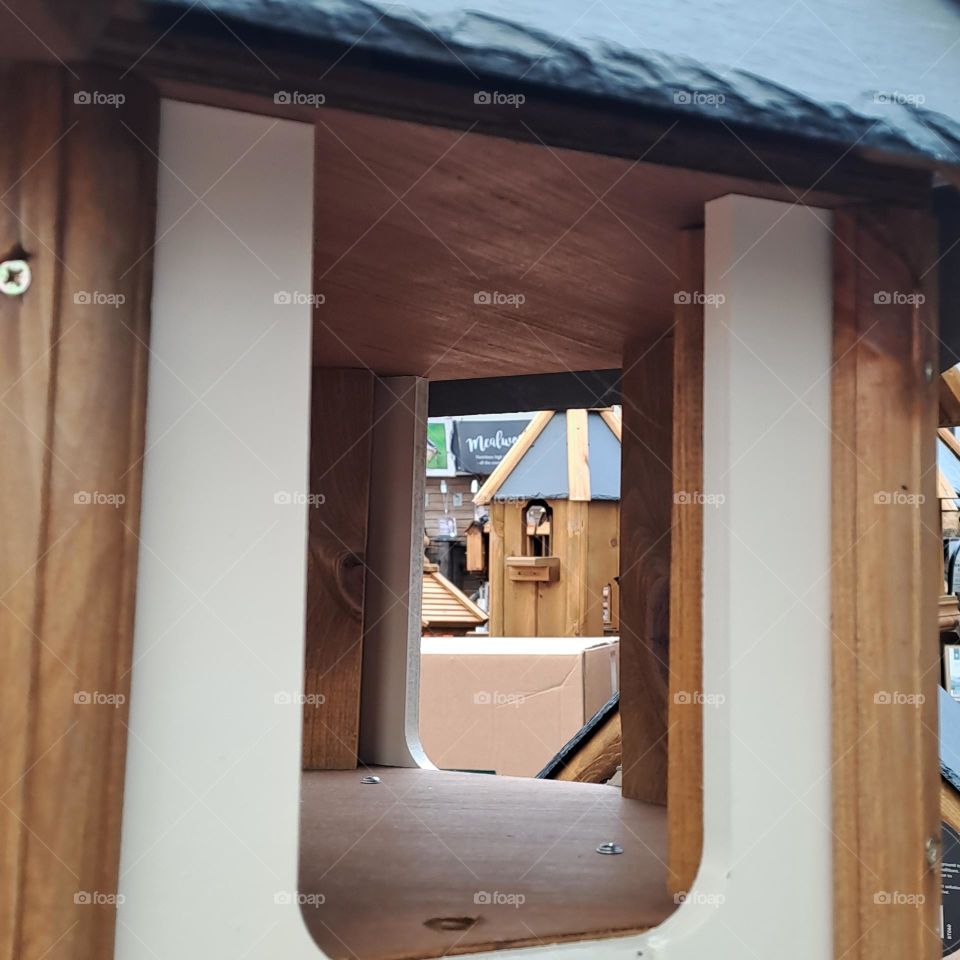 view through wooden birdbox window in a shop selling others square