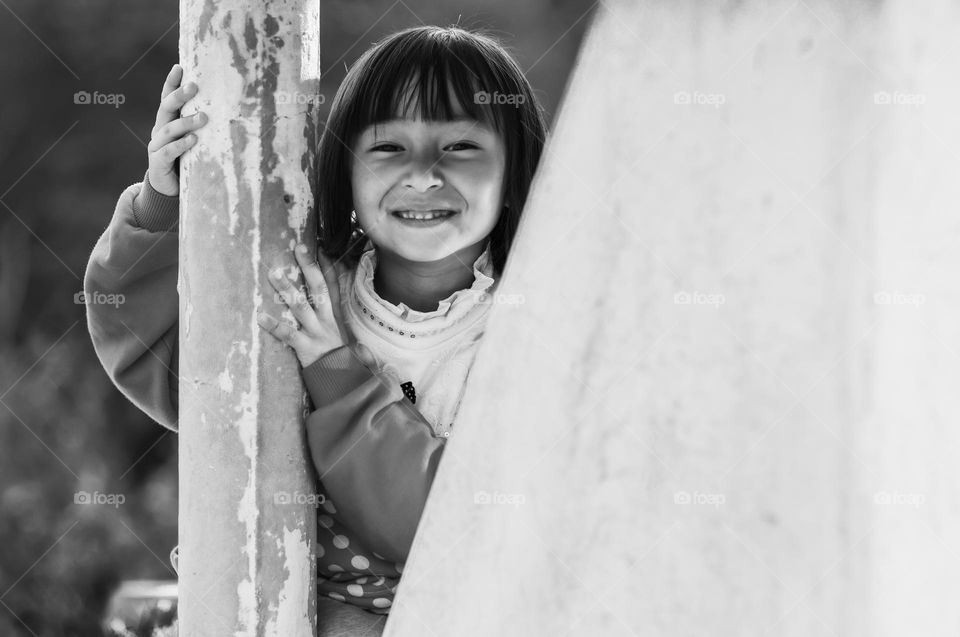 A black and white portrait of a little asian girl.