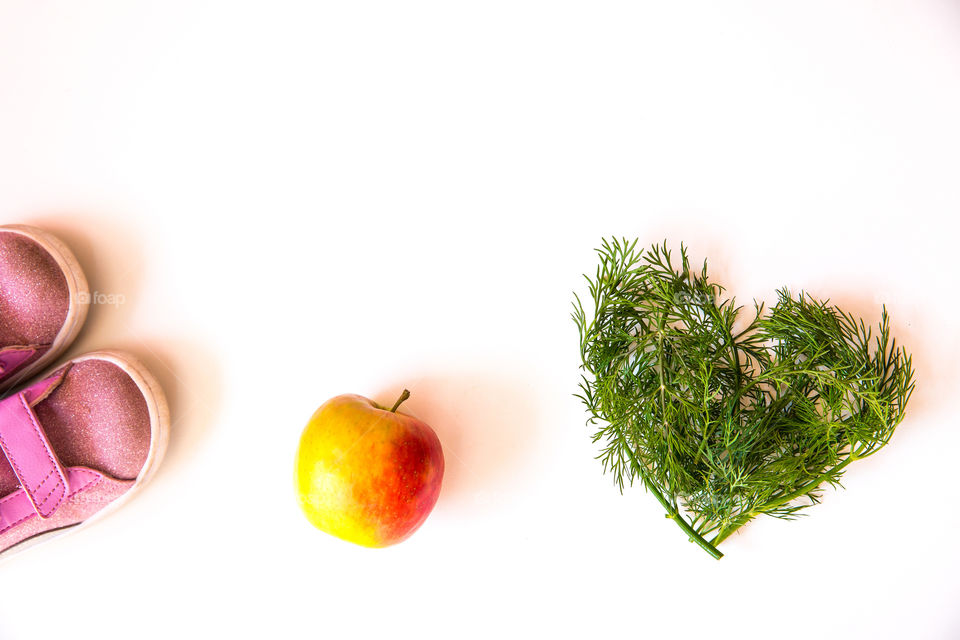 Simple clean image on white background  to show that good nutritious healthy food with exercise and fitness is good for your heart and health. Staying in shape is a combination of healthy food and physical activity.