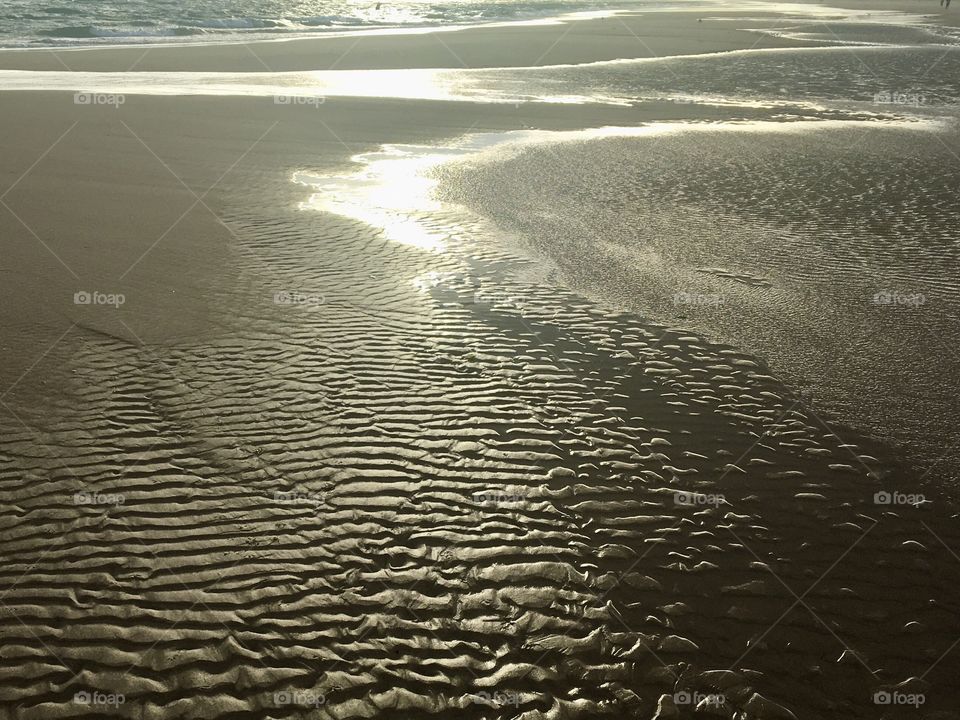 Game of sunshine on beach at low tide