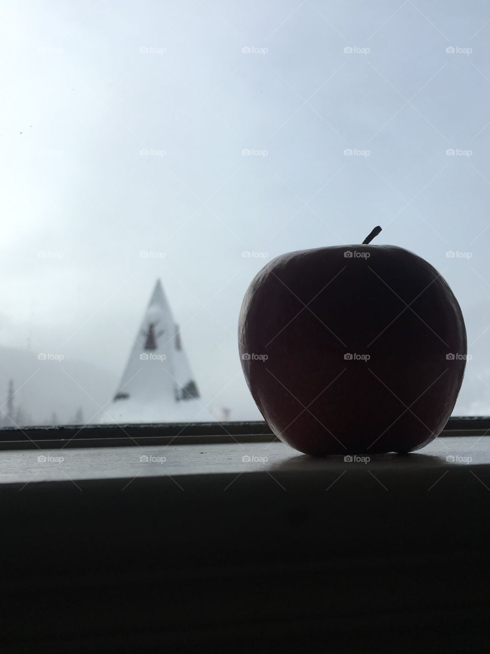 Red apple by window.