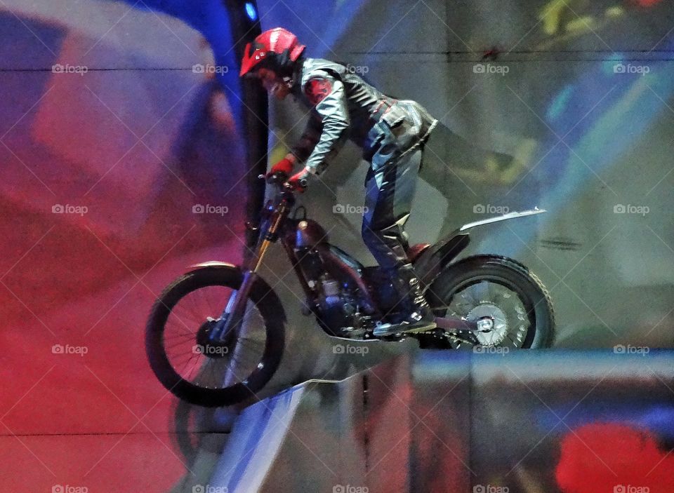 Motorcycle Stunt. Pro Rider Performing A Motorcycle Stunt On A Ramp
