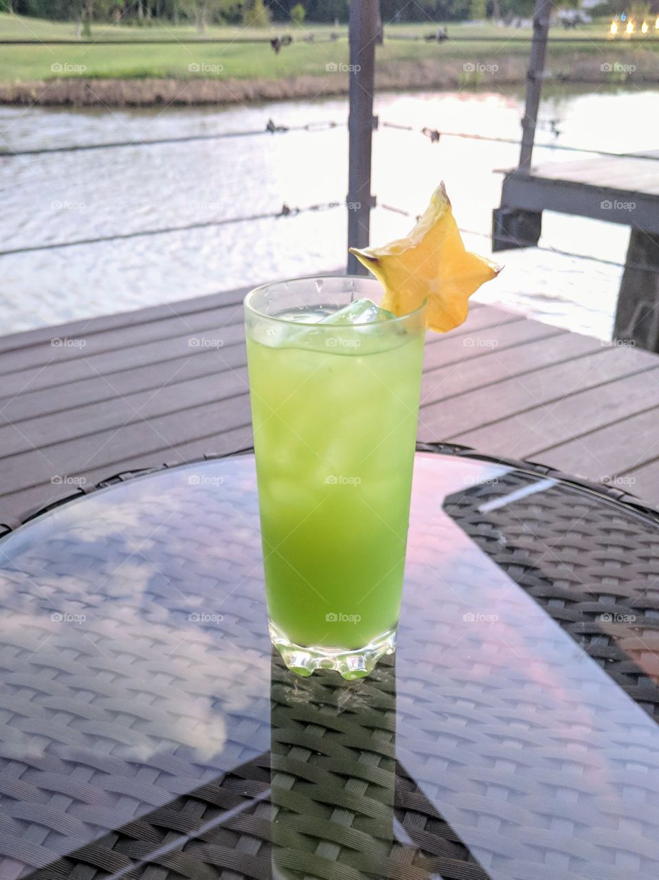 Green cocktail with star fruit garnish