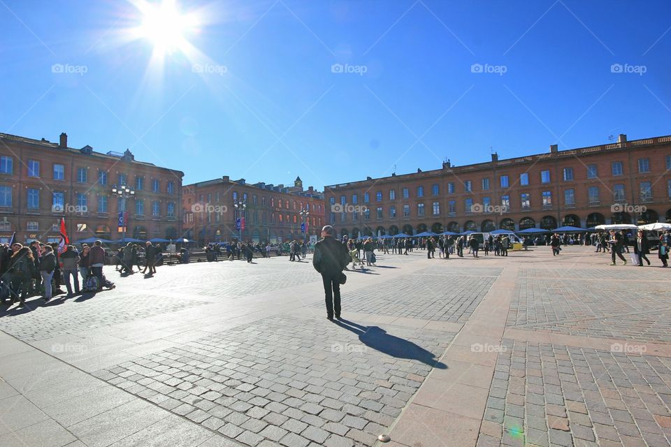 man walking in place of Capitol at Toulouse
