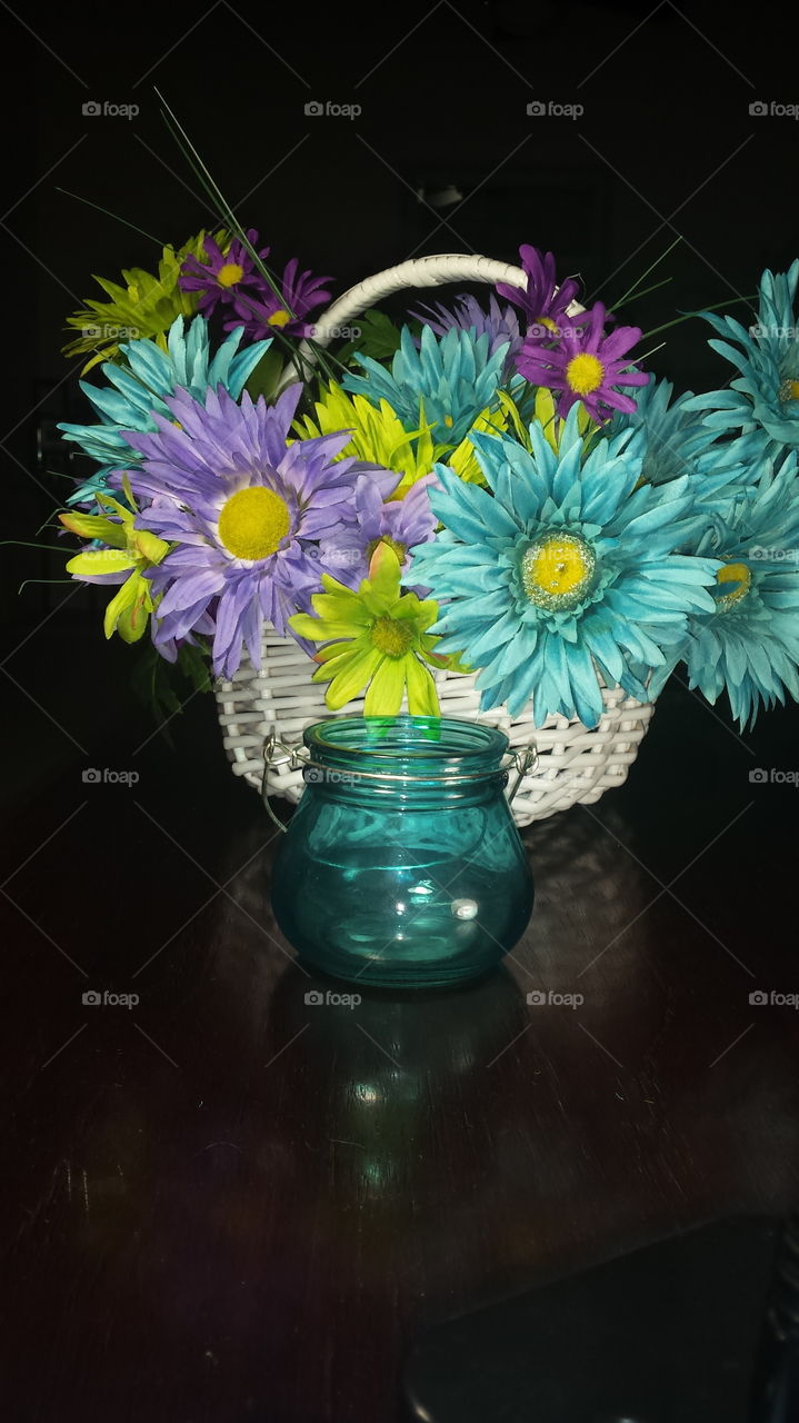 blue clear glass pot and flower basket