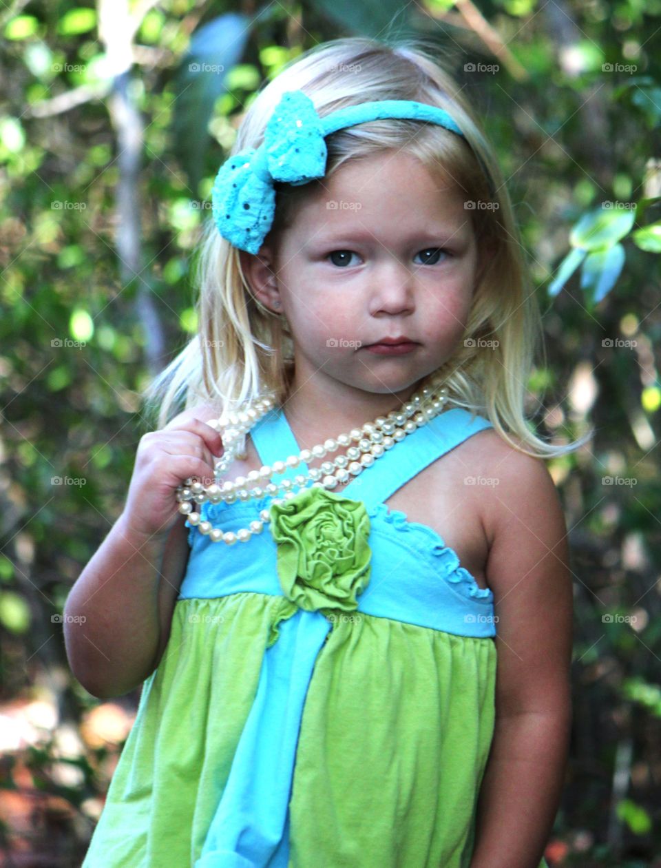 Portrait of cute girl wearing pearl necklace