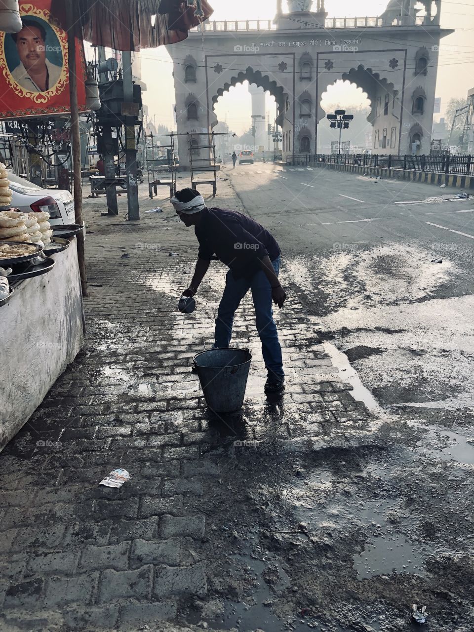 Street Food Vendor cleaning up before he starts work (India)