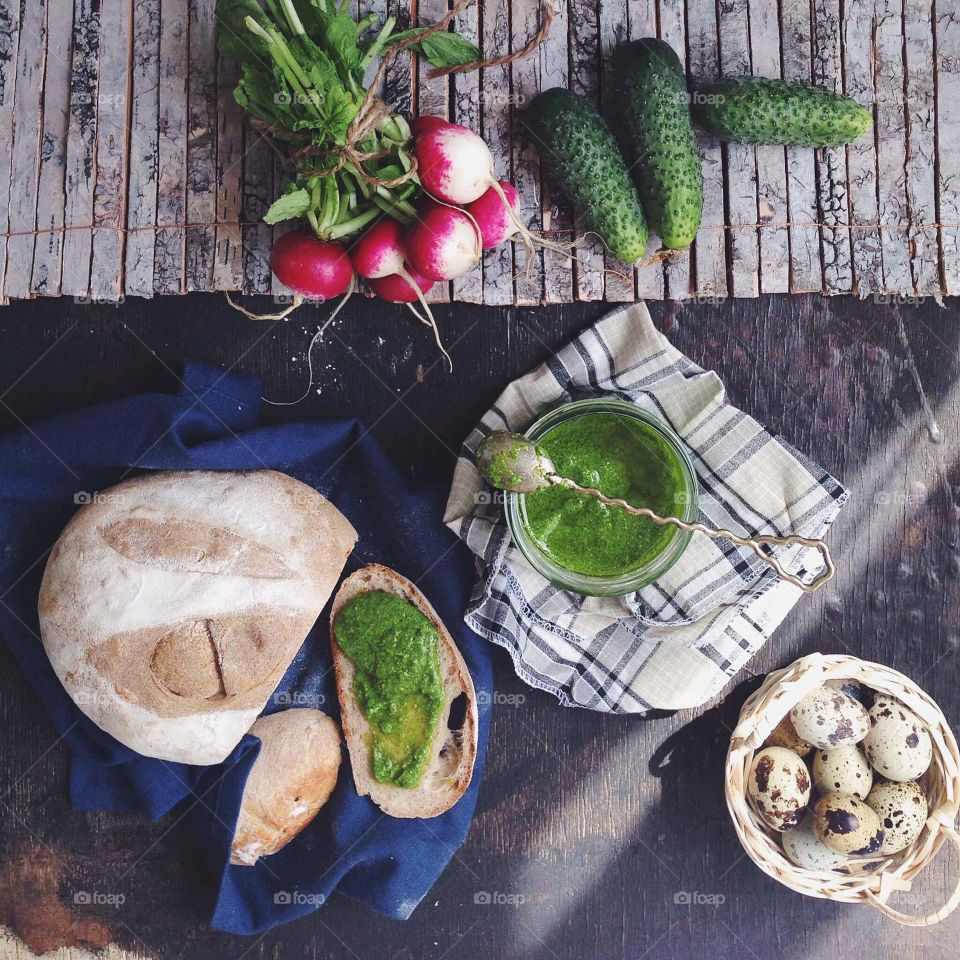 Picnic set: vegetables, pesto sauce, bread, quail eggs 