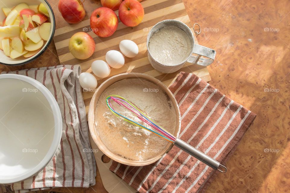 Making homemade puffed apple pie with eggs, sugar and flour.