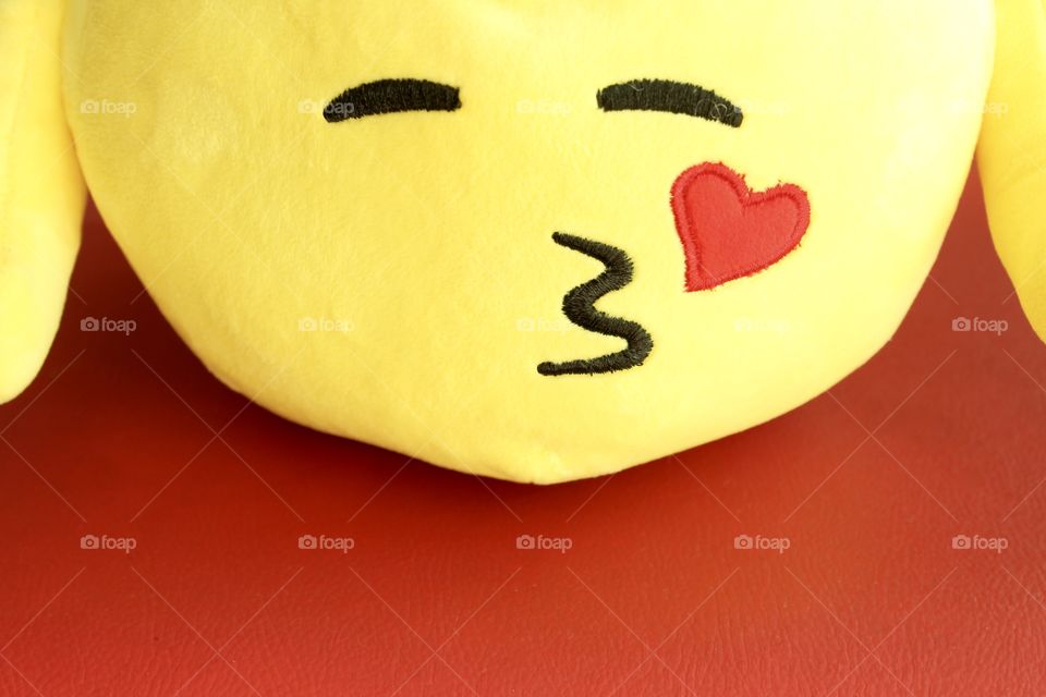 yellow emoji on red background