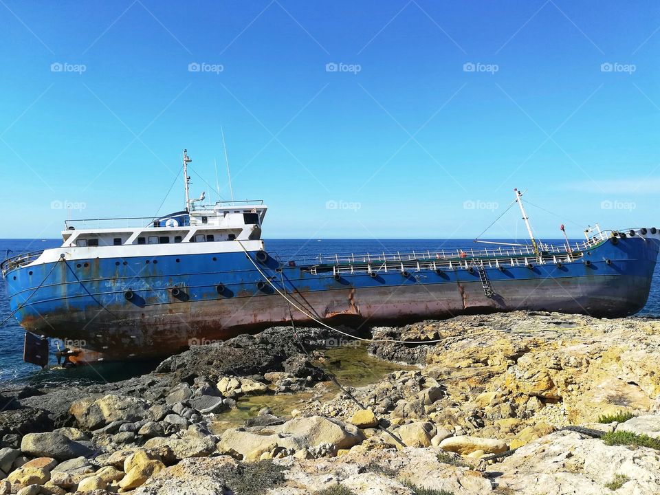 ship wrecked and stranded on the rocks