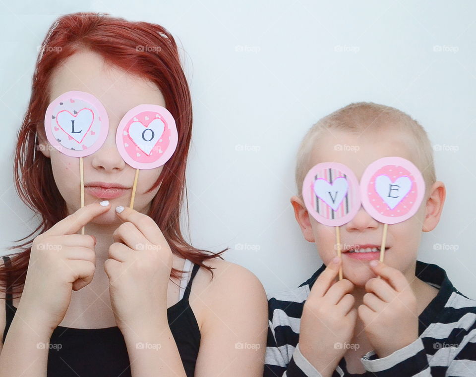 Brother and sister holding love text in hand