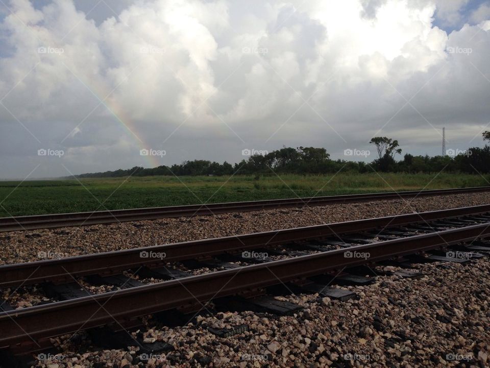 Rainbow over train tracks
