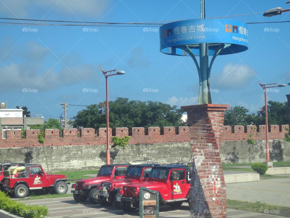 Historic site and red off-road vehicle