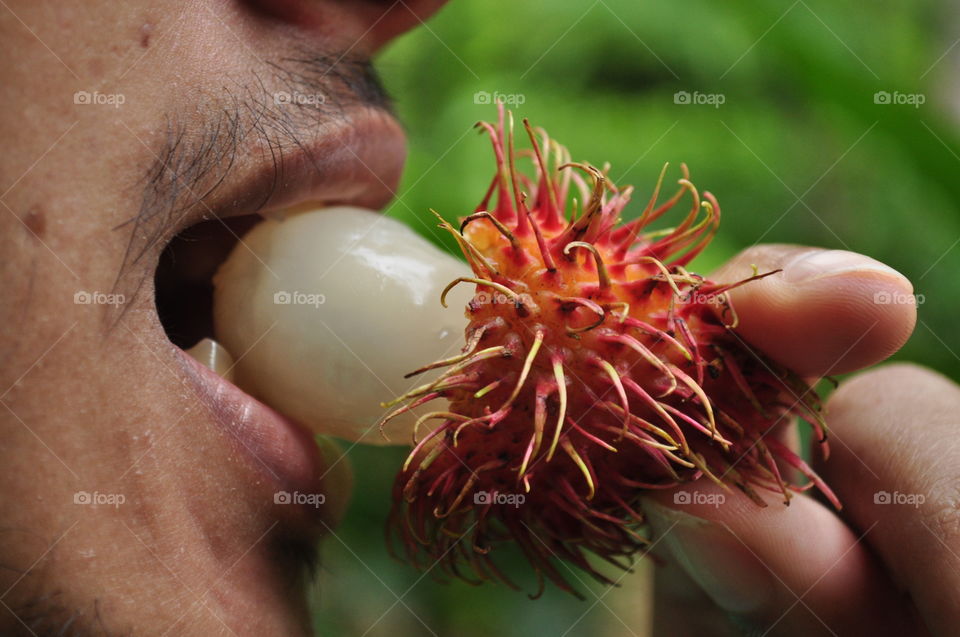 my brother is eating rambutan