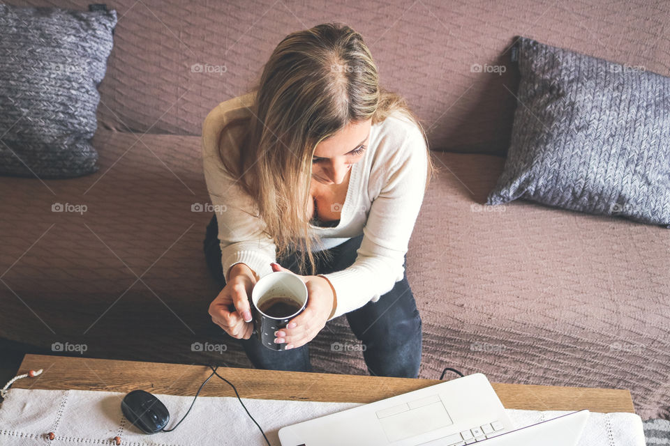A woman drinking coffee at home