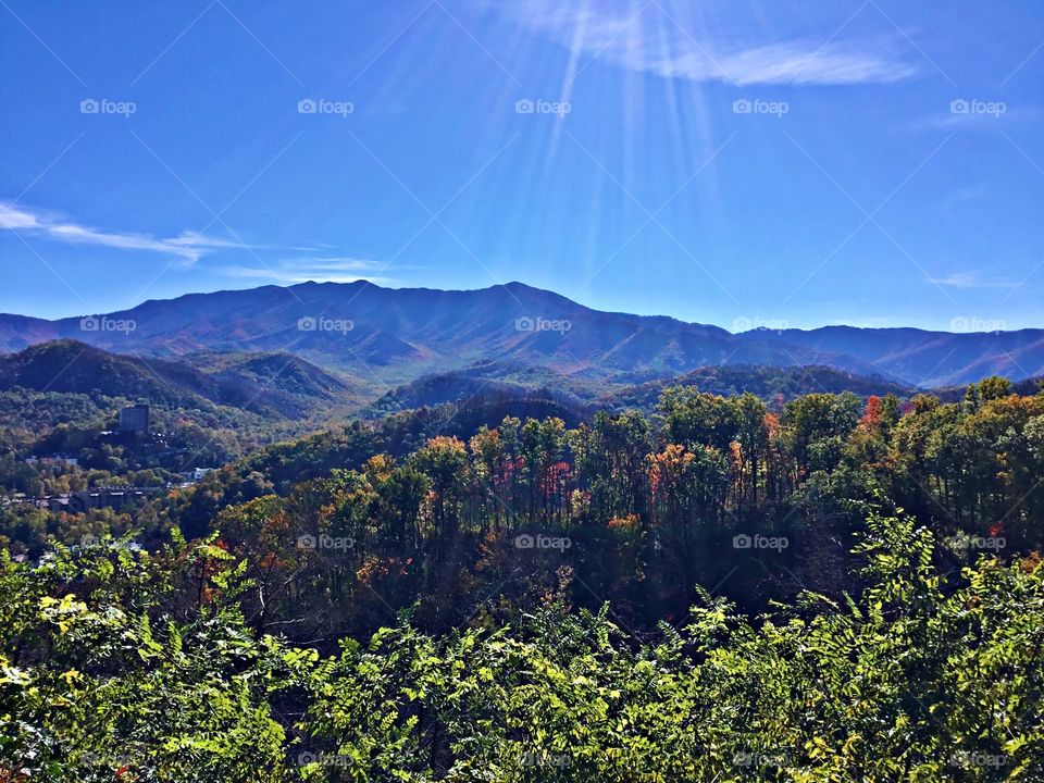 Cities and countrysides - Foap Missions - The rolling hills, green forest and mountains of Tennessee are showered with a blue sky and sun rays 