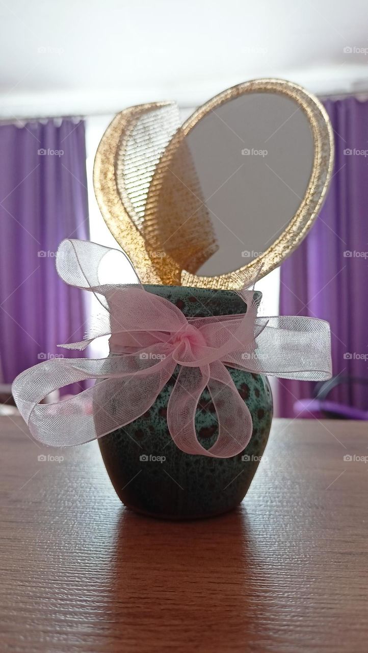 still life, clay vase with ribbon, pink ribbon, vase on the shelf, window, curtains, purple, lilac, mirror, hairbrush