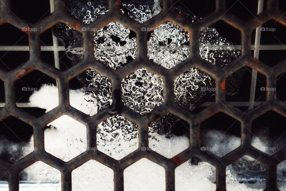 Close up of Ice Behind the Grill of a Pick Up Truck on a Cold Morning