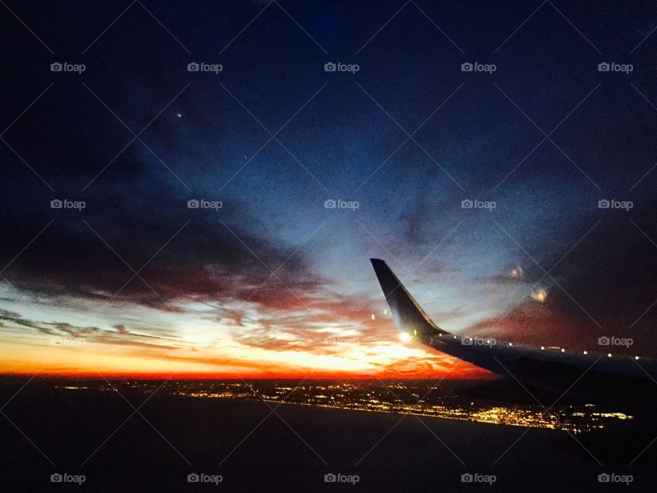 Beautiful sunset from a airplane with the wingtip 
