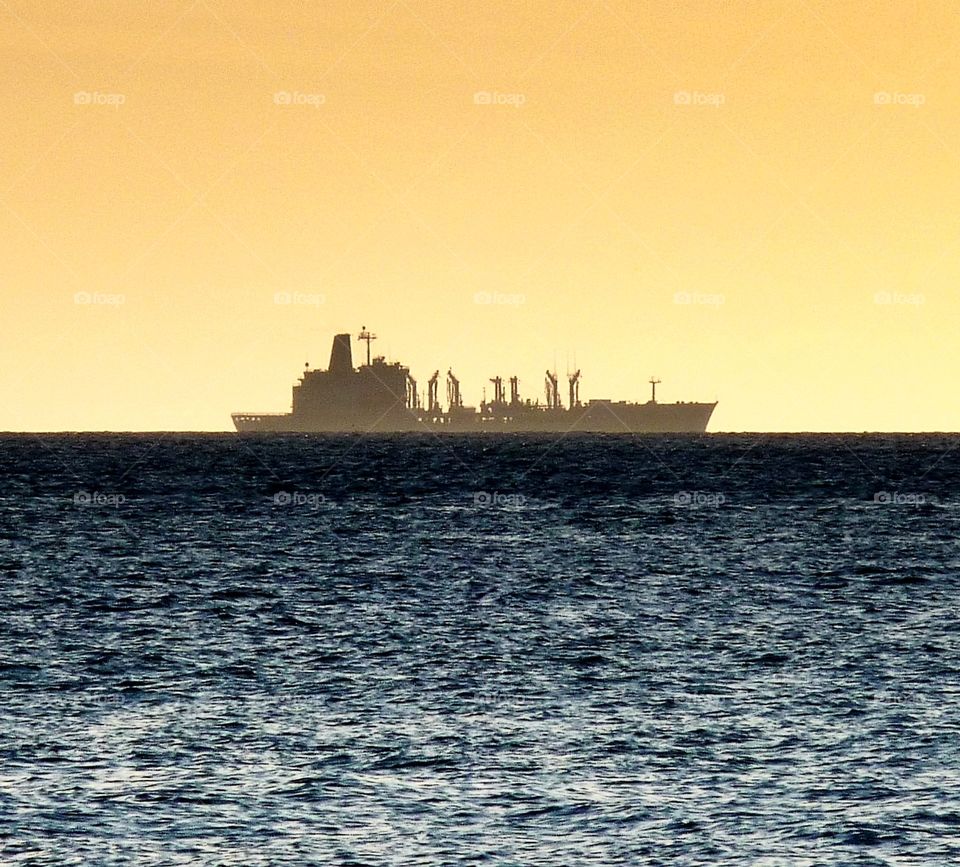 Shipping on the horizon at sunset in the Pacific Ocean off Hawaii