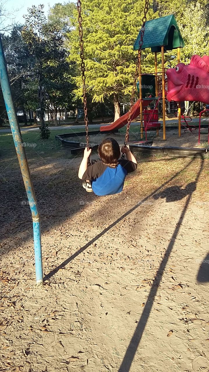 boy swinging