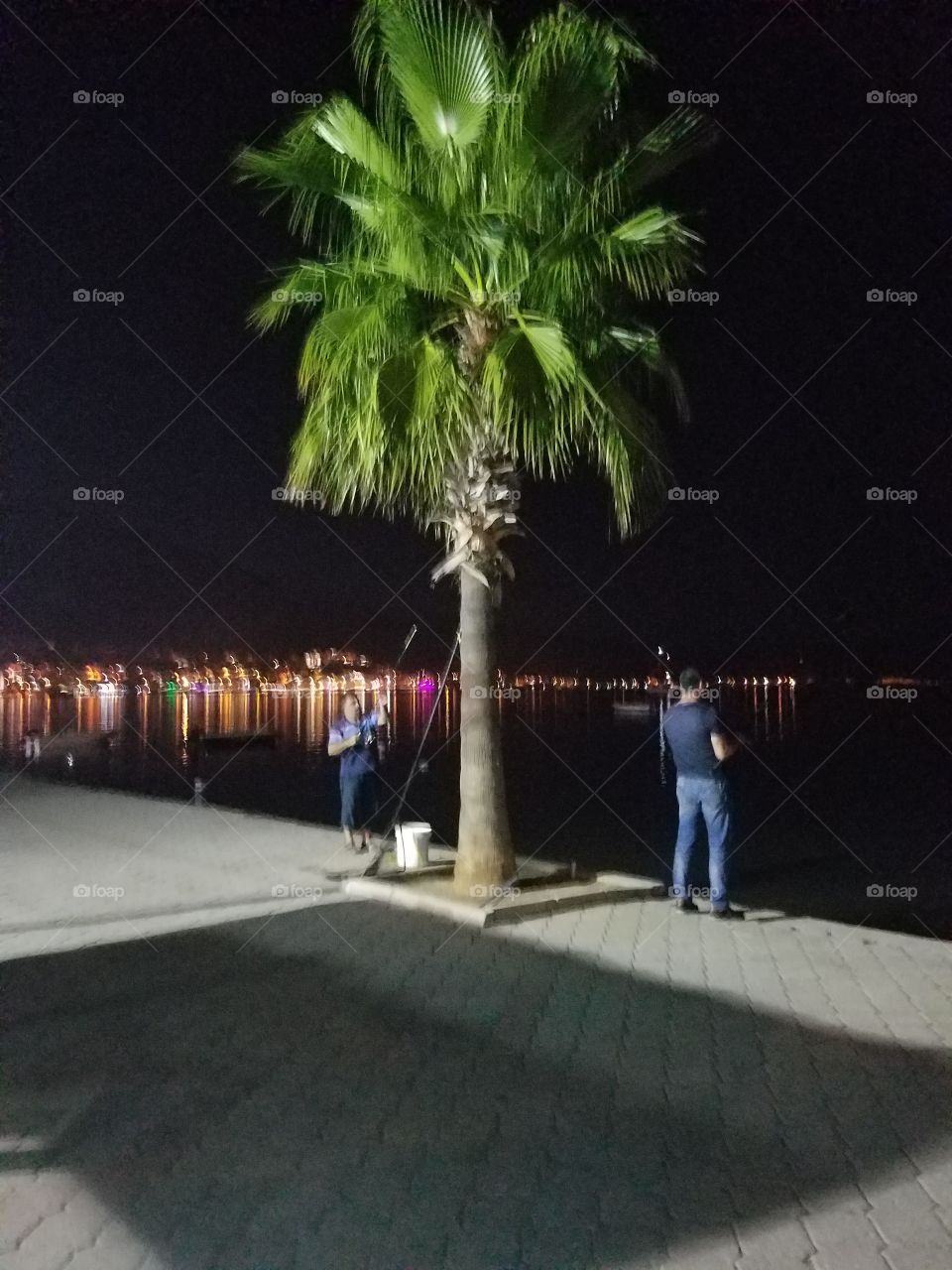 two men fishing off the harbor in fethiye turkey