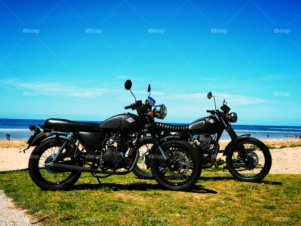 Black motorcycles on the beach 