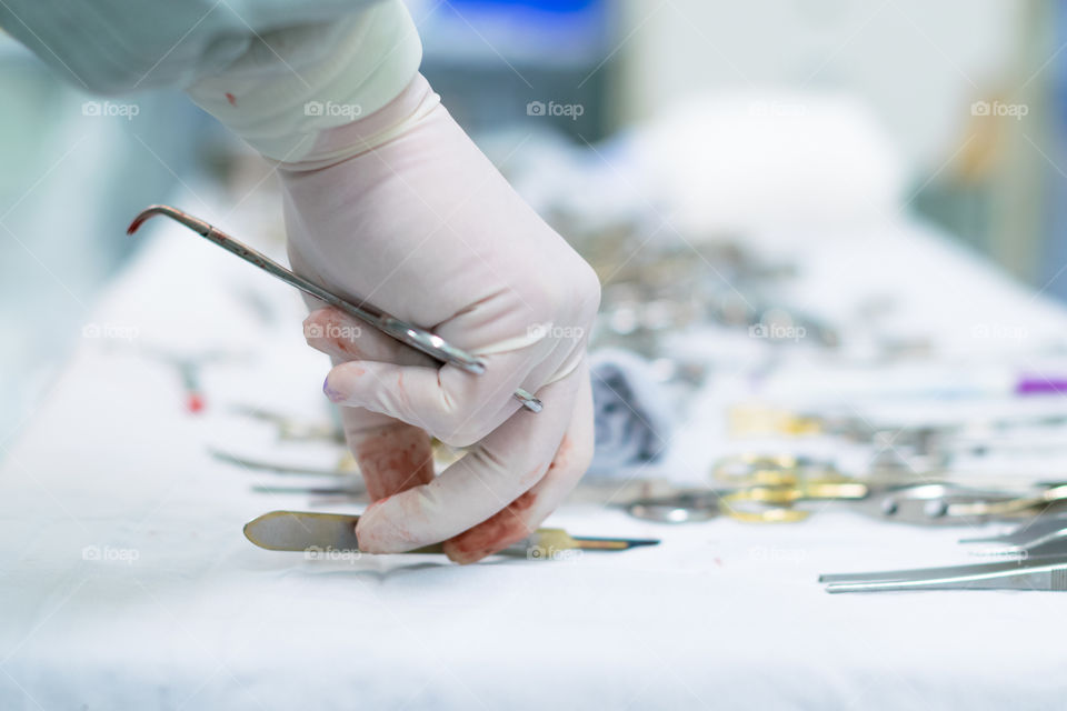 Close-up of surgeon's hand holding medical equipment