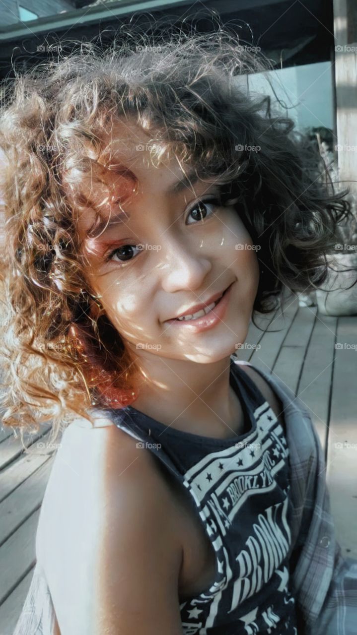 Curly haired girl in the sunlight