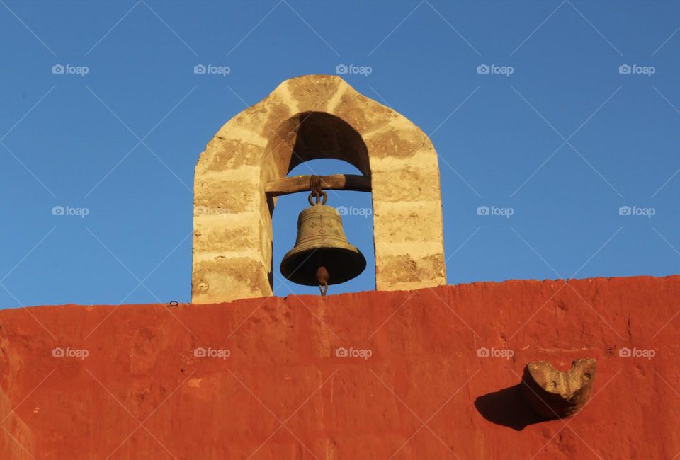 Little metal bell on a wall of a house in Arequipa in Peru.