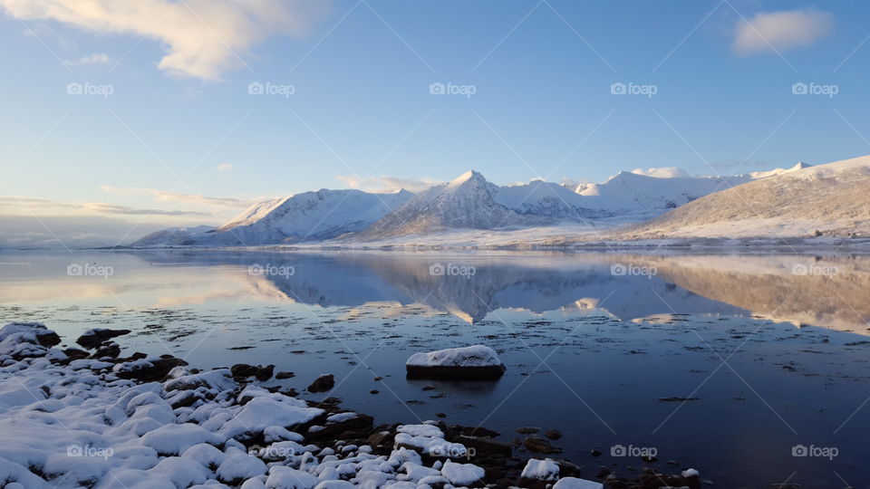 Reflection of snowy mountain on lake