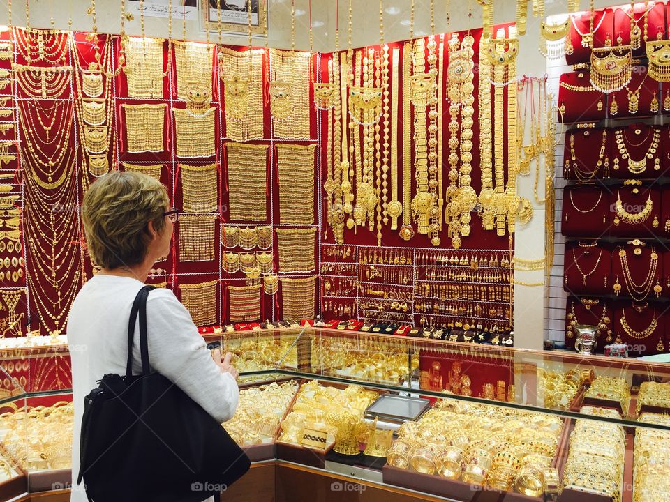 Tourist admiring tons of karats of gold and jewellery at the Abu Dhabi gold market 