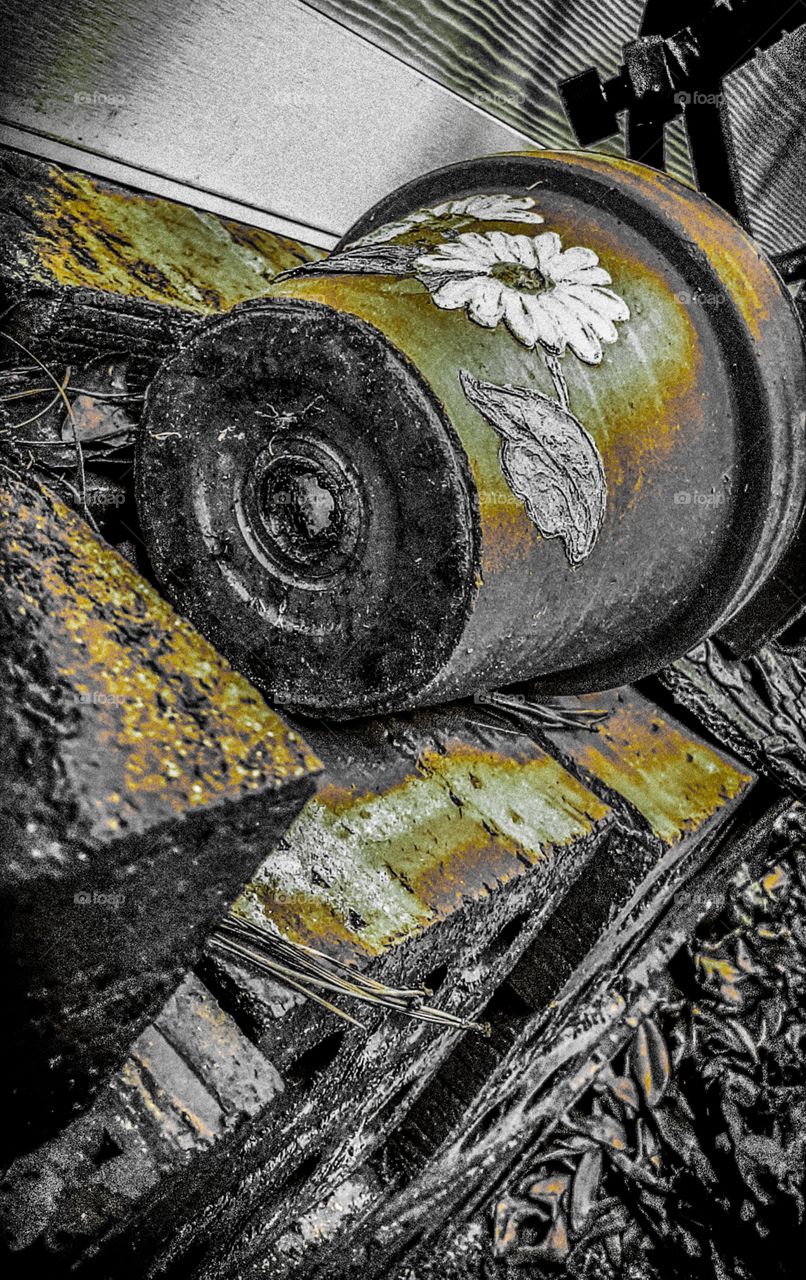 flower pot resting on stack of bricks