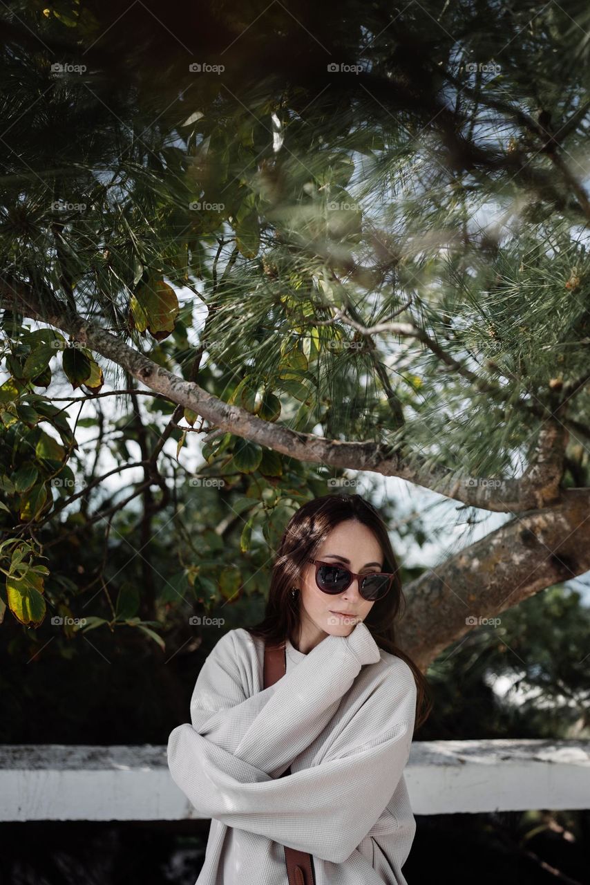 Portrait of beautiful woman among pine branches