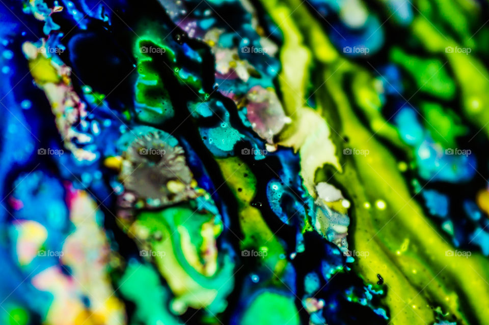 The ink to refill the printer cartridge was spilled onto the white washbasin and the paints blended into abstract drips and patterns.