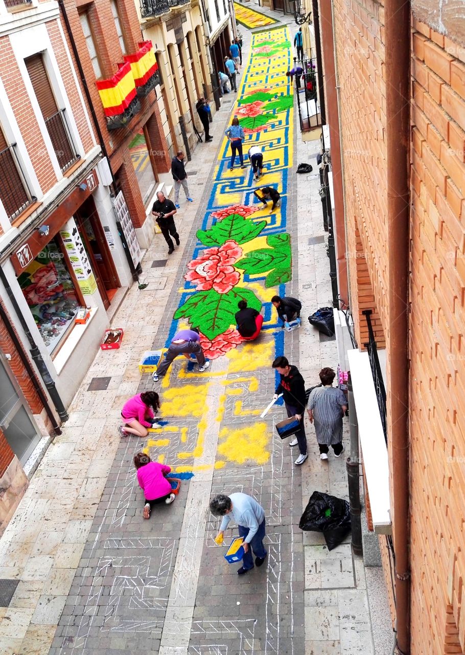 decorating a street with flowers in the festivity of the village