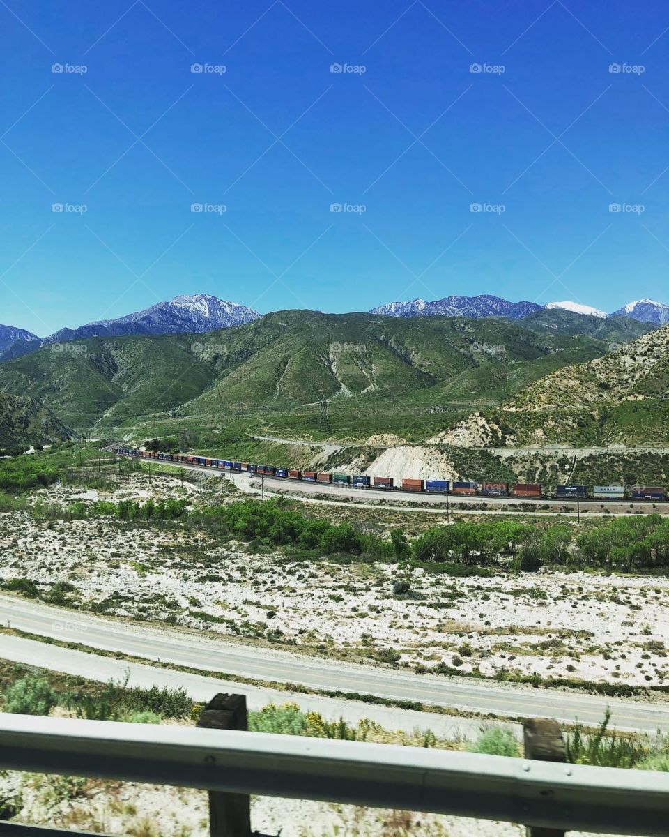 A train track cuts through the mountains in Cajon, California.