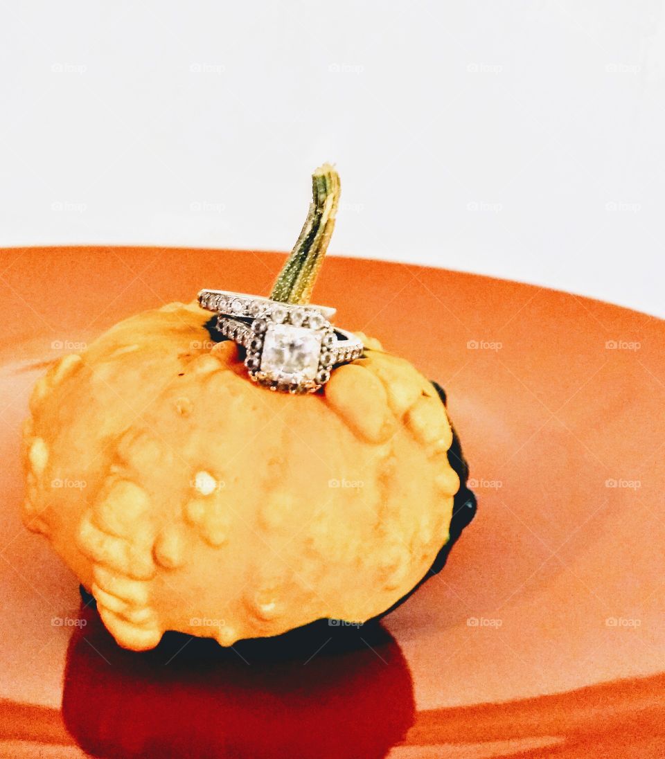 small pumpkin with wedding ring on it's stem