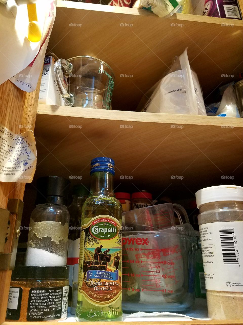 Carapelli Extra Virgin Olive Oil in cooking cabinet.