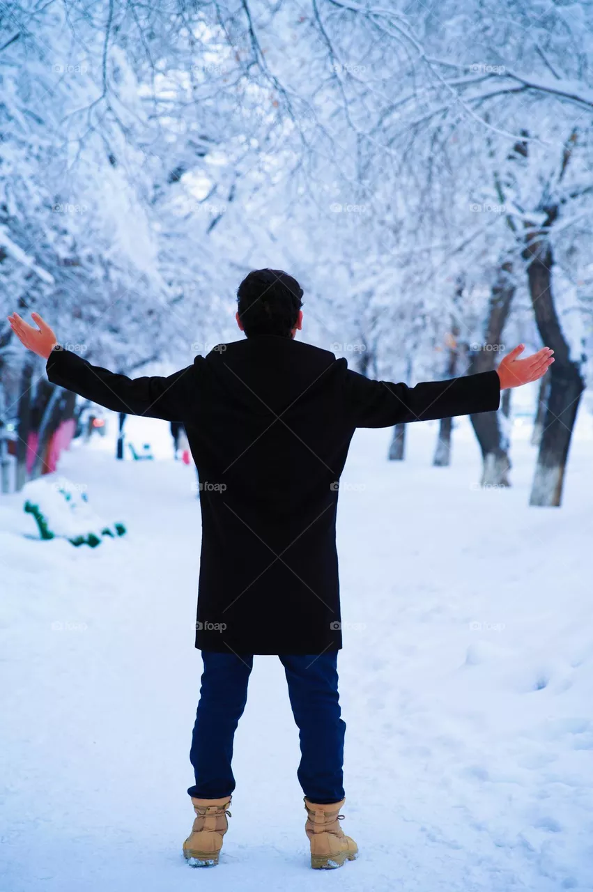 Standing in white snow path with beautiful trees 