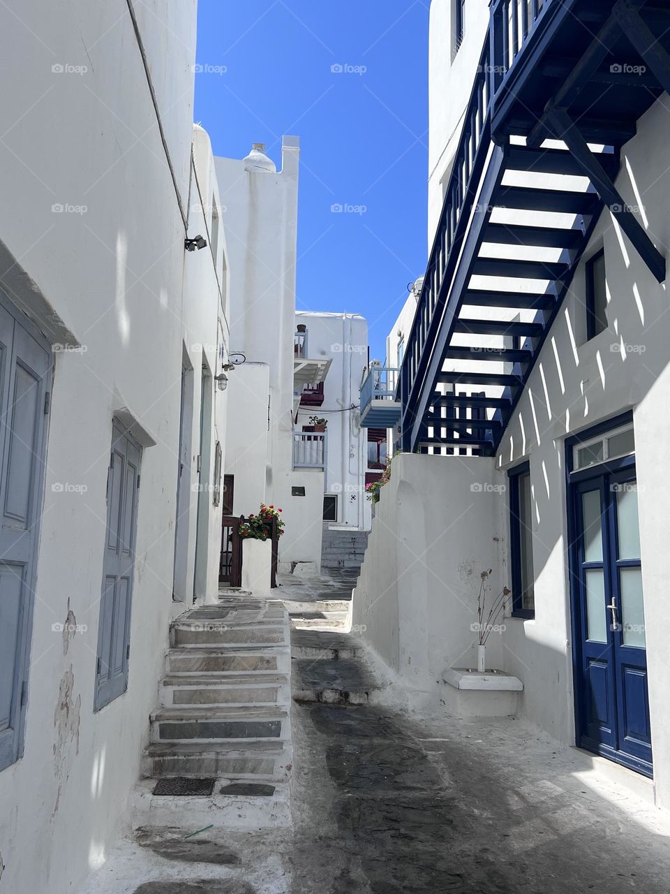 A rare quiet moment in Mykonos, Greece. A road less traveled. A place where the locals who live and work. 