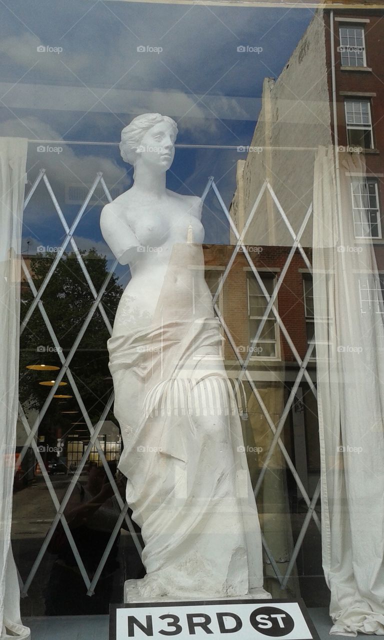 Window Statuette. next to the creepy clown windows in downtown Philly