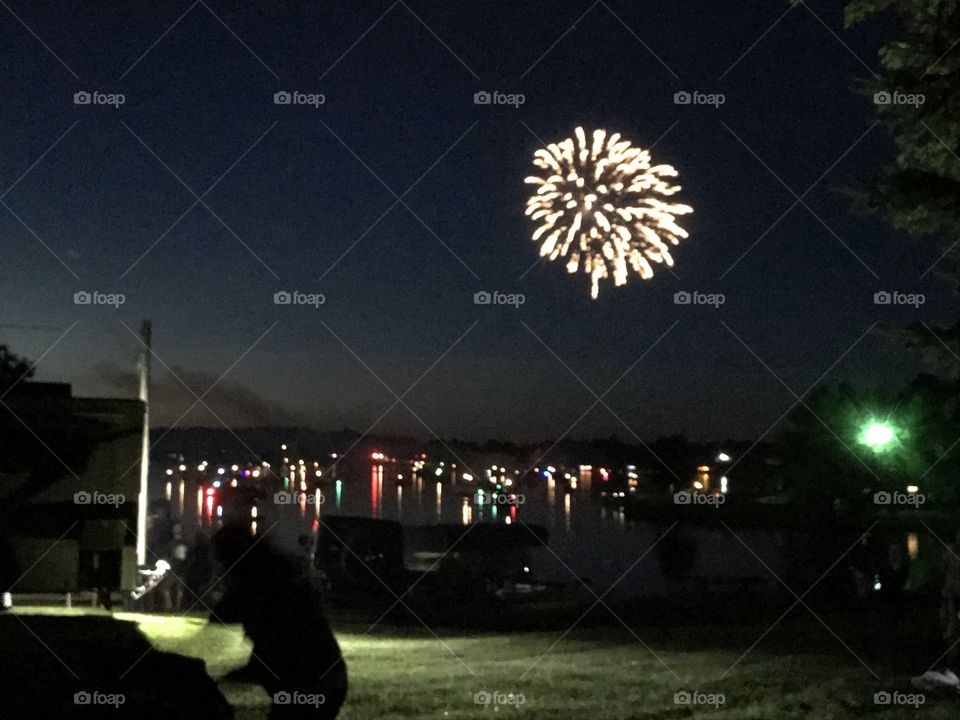 July 4, 2018. Families in boats on the lake enjoy a spectacular show of fireworks and music. 