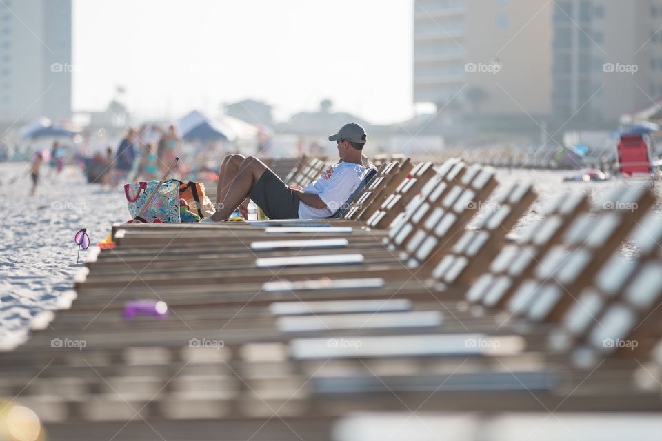 Man laying on the beach chair 