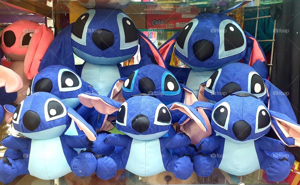 stuffed animals from the animated series lilo and stitch.  fancy blue