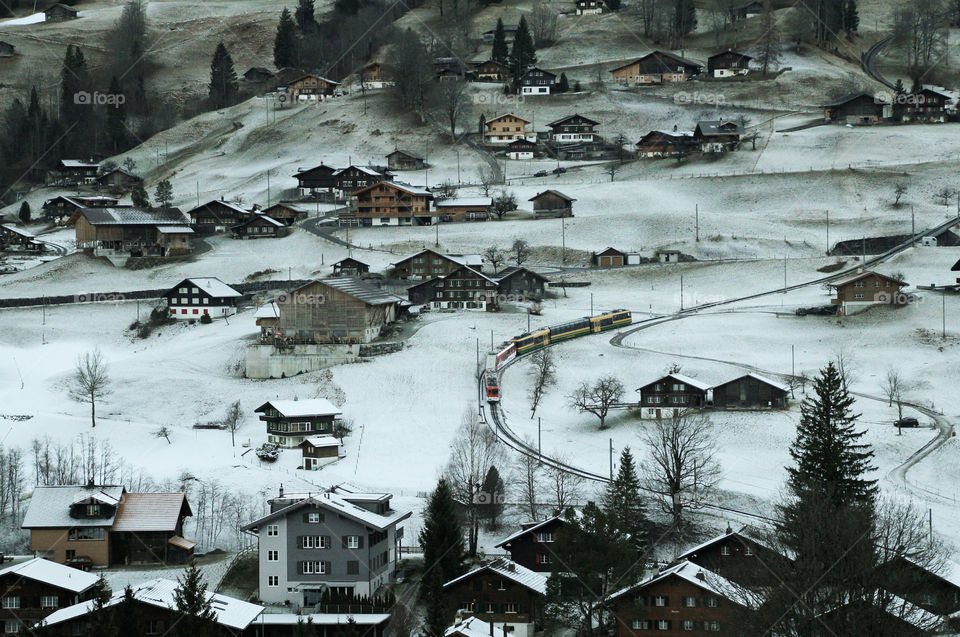 Grindelwald village in the canton of Bern in Switzerland. The village is surroundend by a mountain range.

Grindelwald railway station is served by trains of the Berner Oberland Bahnand of the Wengernalpbahn.

This village is long famed as a winter touriat destination.