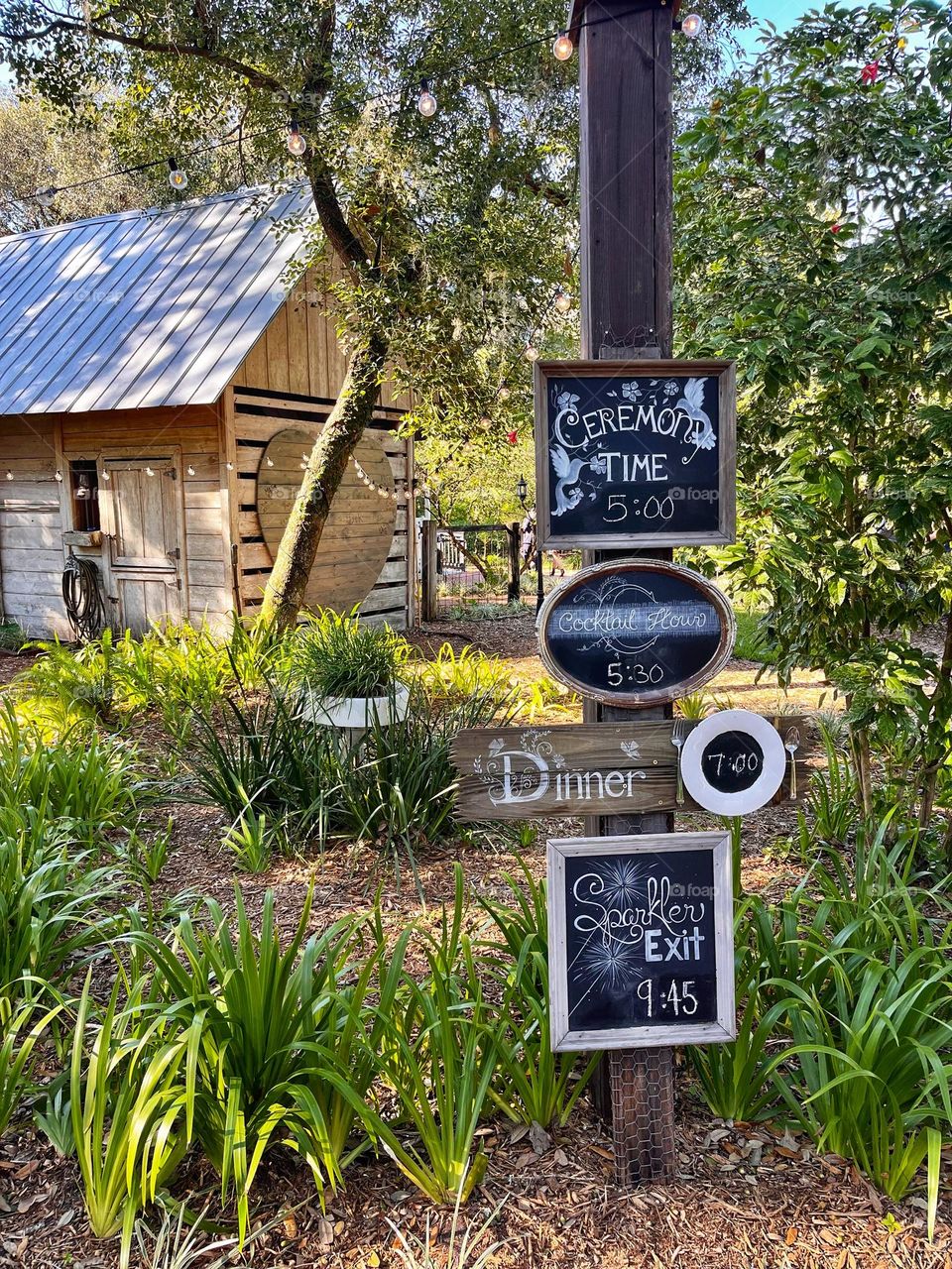 Signs at an outdoor wedding in the country on a farm outside a barn
